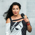 Image of Stacy with a microphone